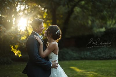 Bride & Groom embrace in the setting sun on their wedding day at the Woodlands Hotel