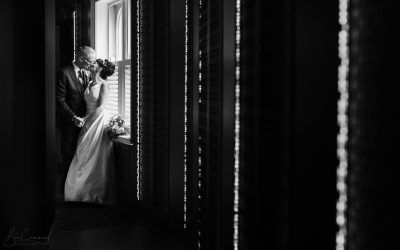 Bride & Groom Pose in a window at the manor house lindley