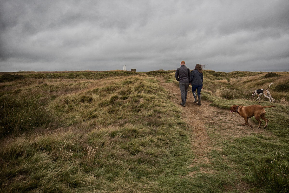 A couple walking their dog during Anna & Ryan's Pre Wedding Shoot on Baildon Moor.