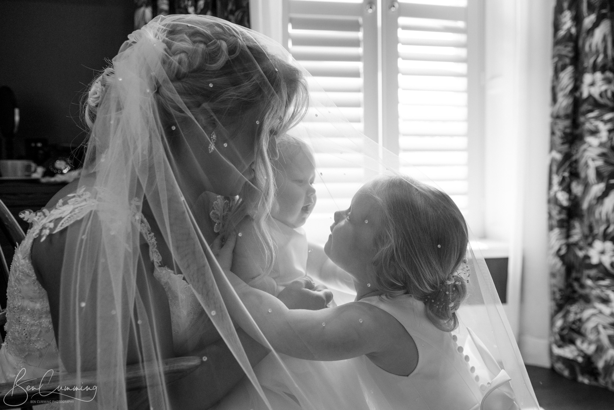 Bride and her Daughters under the wedding veil at Manor House Lindley