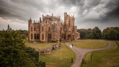 Bride & Groom Walk back to the castle in the rain. Drone photo