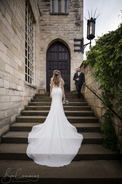 Bride and groom on the steps at Hazlewood Castle