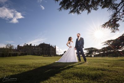 Bride and Groom pose in the sunshine at Allerton Castle