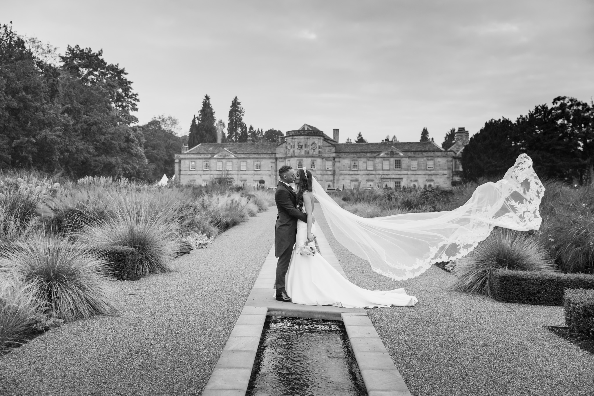 Bride and groom and wedding veil at Grantley Hall