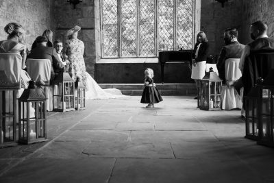 A little girl is walking down the aisle at The Priests House wedding.