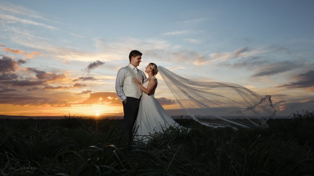 Bride & Groom pose at Sunset on their Wedding Day