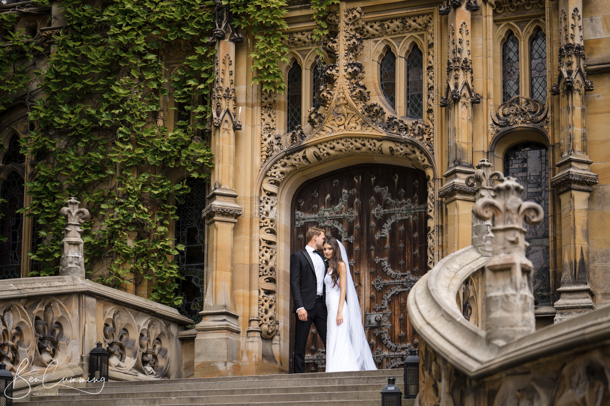 A Carlton Towers wedding photographer captures a bride and groom on the steps of an ornate building.