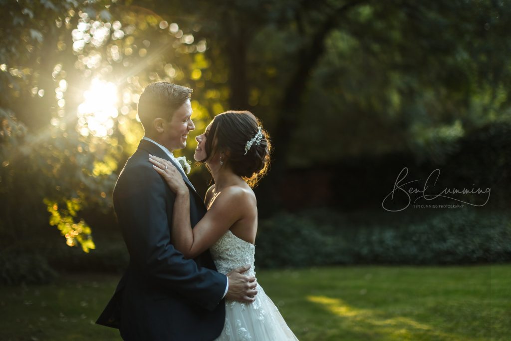 a couple embracing in wedding attire under the sun at one of the best yorkshire venues.
