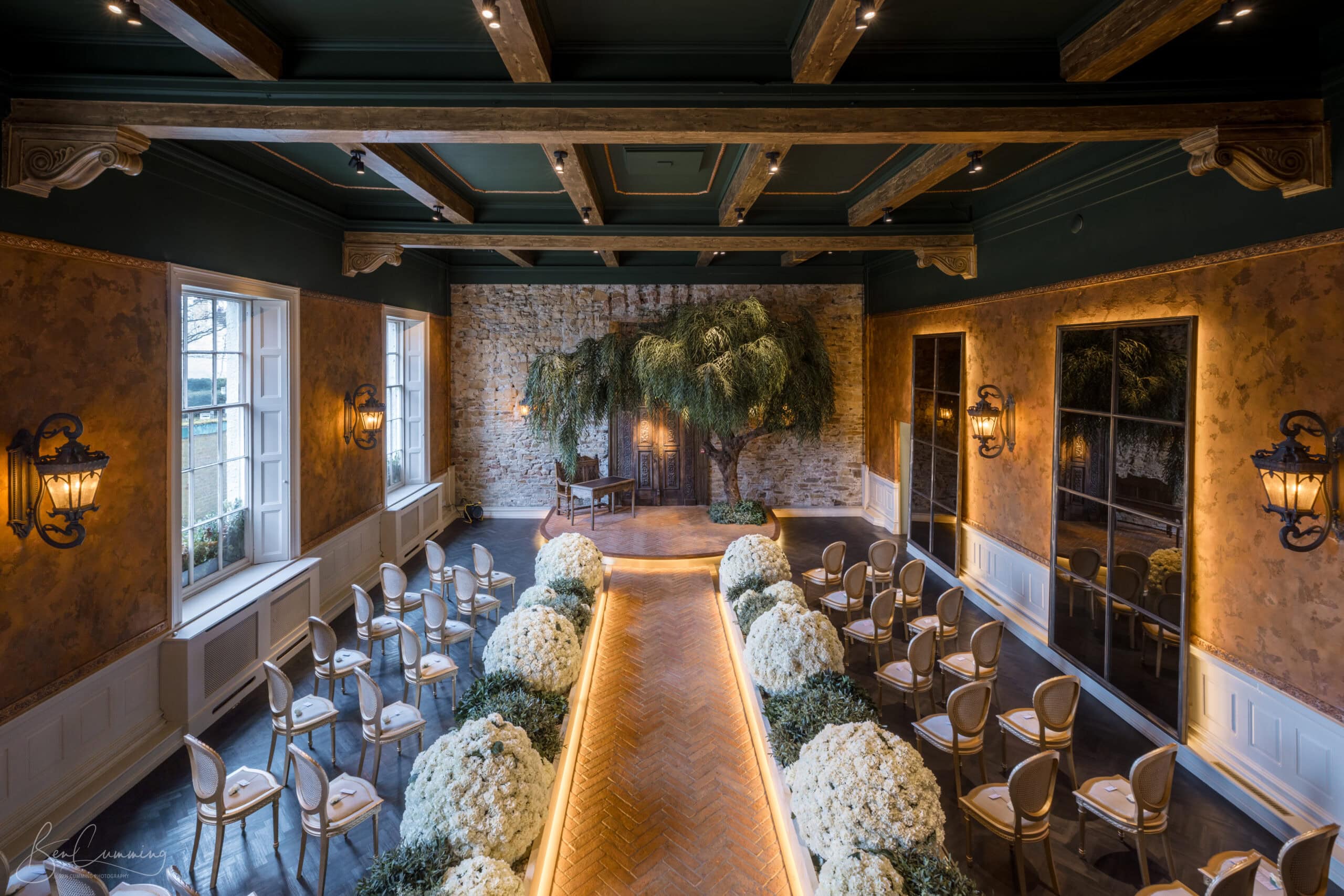 The Secret Garden Chapel at The Croft Hotel dressed for a wedding ceremony with florals and vintage lanterns