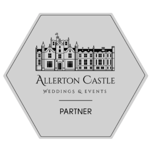 hexagonal badge featuring a line drawing of a castle with the text "allerton castle weddings & events partner" about it. image by yorkshire wedding photographer ben cumming photography.