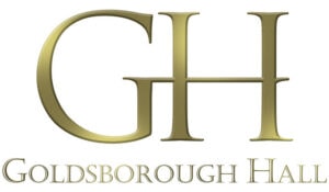 the image elegantly presents the logo for goldsborough hall, with large golden letters "gh" above the words "goldsborough hall" in a sophisticated serif font, embodying everything about timeless elegance and refined taste. image by yorkshire wedding photographer ben cumming photography.