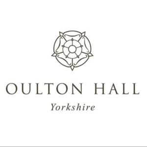 about the logo of oulton hall, yorkshire: it features a stylized floral emblem resembling a rose above the text "oulton hall yorkshire" in an elegant, serif font on a pristine white background. image by yorkshire wedding photographer ben cumming photography.